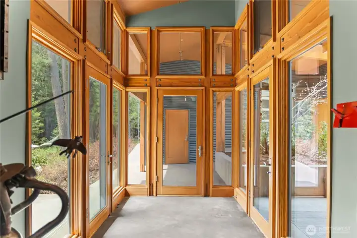 The heated atrium entry has doors that open to the terrace or lead to the garage and storage.