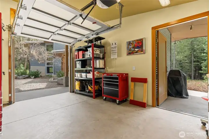 The heated shop has a roll-up door and also opens to covered barbecue area hidden from view but easily accessible for terrace parties.