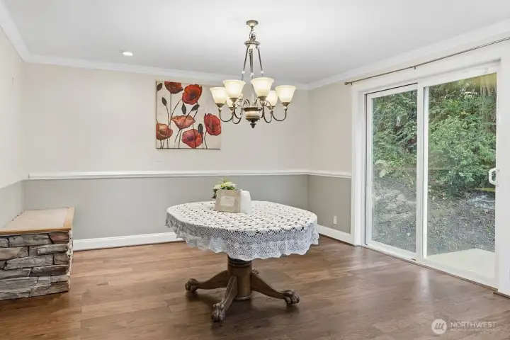 The formal dining room has a glass door that opens to the natural back yard and greenbelt.