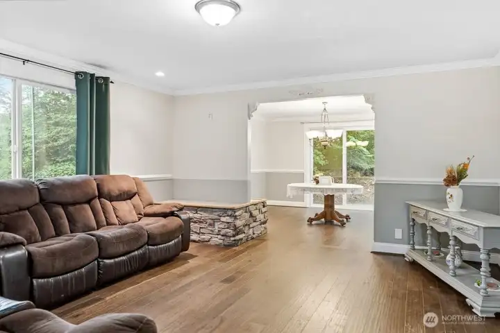 The living room with open archway to the formal dining room.