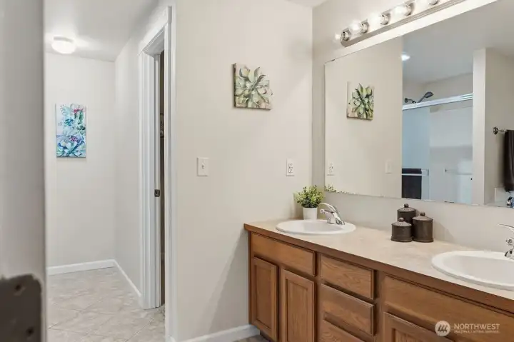The primary suite bathroom has double vanity and soaking tub and shower.