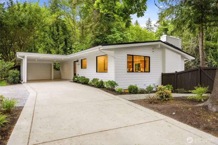 Expansive circular driveway creates a grand first impression with generous parking and easy access.