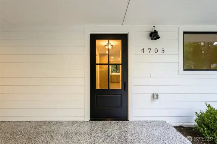 Modern front entry with updated exterior finishes and a clean, welcoming feel.