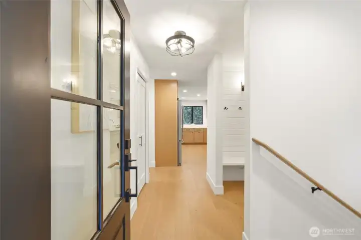 Bright entryway with fresh flooring, updated lighting, and a beautifully renovated first impression.