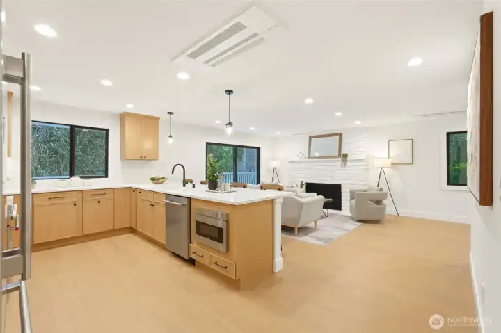Open-concept main living area with warm white oak tones and a fresh modern organic aesthetic.