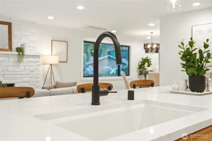Statement sink, modern fixtures, and quartz surfaces add a high-end designer touch.