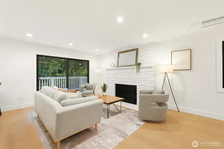 Light-filled living room with fireplace, updated finishes, and a calm, inviting feel.