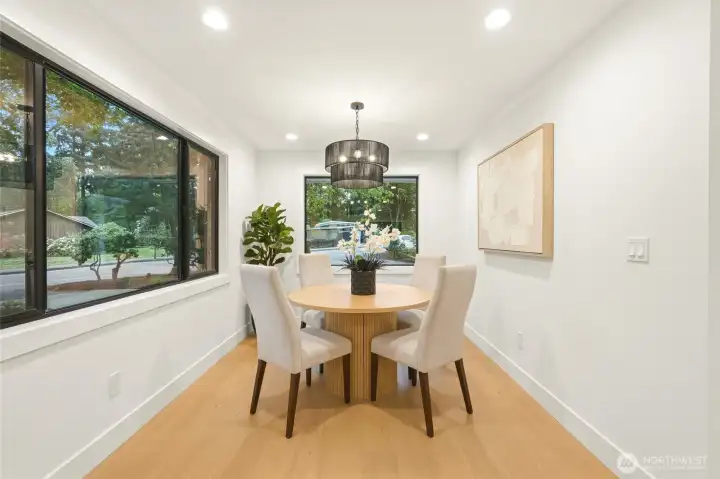 Charming dining nook surrounded by windows, perfect for everyday meals or morning coffee.