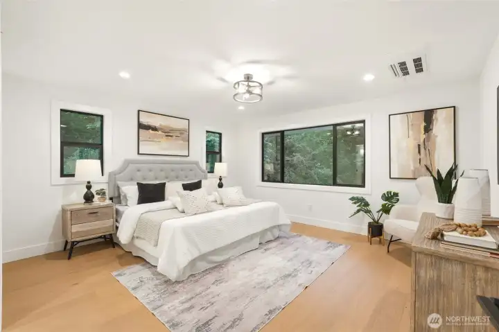 Main-level primary suite with generous space, natural light, and a serene renovated feel.