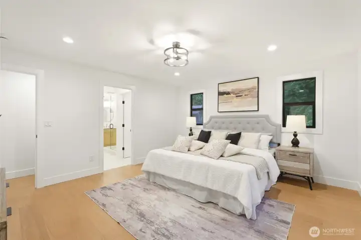 Spacious primary bedroom designed as a calm retreat with updated finishes throughout.