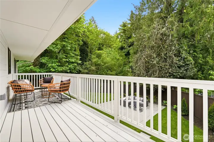 Spacious upper deck overlooks the refreshed yard and creates an ideal setting for outdoor dining or relaxing.