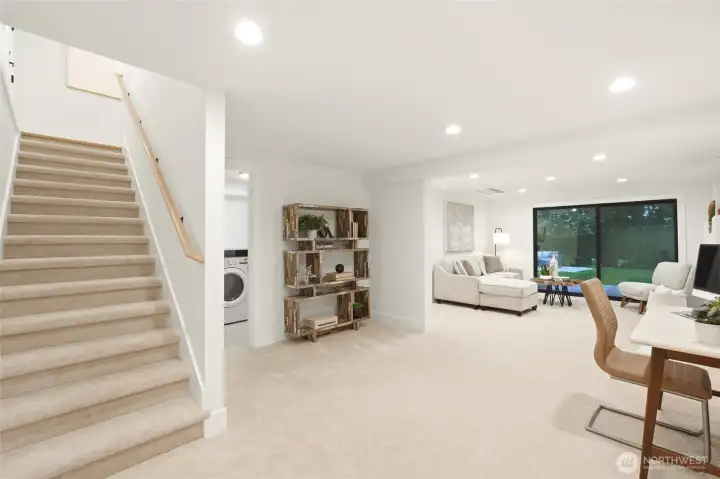 Finished lower level offers flexible living space, a second fireplace, and direct access to the backyard.