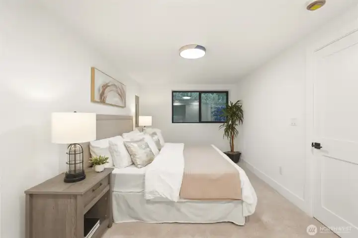 Additional lower-level bedroom offers comfortable space for guests, office use, or everyday living.