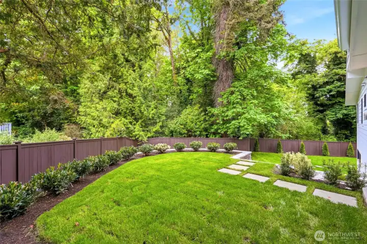 Fully refreshed backyard with new sod, plantings, fencing, and generous space to enjoy.