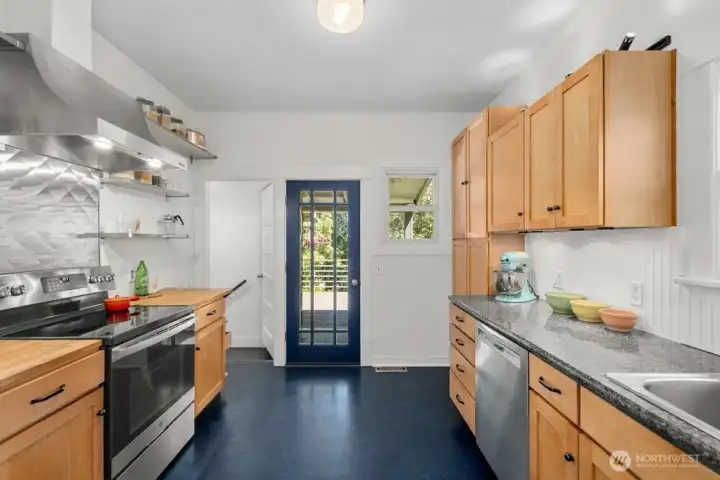 The kitchen offers direct access to the large deck overlooking the garden.
