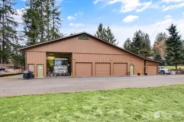 3,960 Sq. Ft. Dream Shop w/RV Parking, Two Waste Dumps, Dedicated indoor RV Parking with oodles of space around this 37 footer, Commercial Grade Flooring in the middle three Bay Door section to left of the Man Door, Two hanging furnaces, Full Bath, Newly Carpeted Office pre-plumbed for Kitchenette, wired for internet and land line, W/D Hookup and lawn mower Bay with separate Metal Door, Lockable Tool Room & tons of outlets.