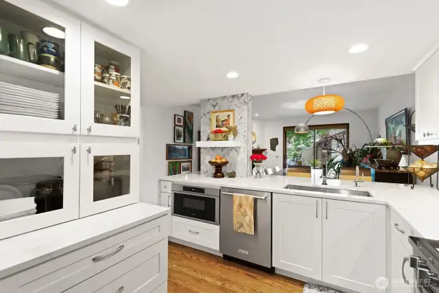 The glass door cabinets are the perfect place to store coffee, tea and the expresso machine.