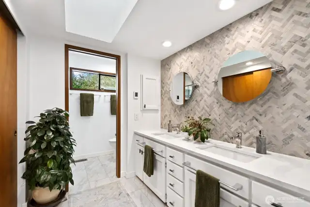 The primary bath features a double vanity and beyond the door is the shower and toilet area. This vanity will keep all of your toiletries at hand, yet out of sight 'til needed. The tile flooring in both this area and the shower room provide a heated floor for additonal warmth & comfort.