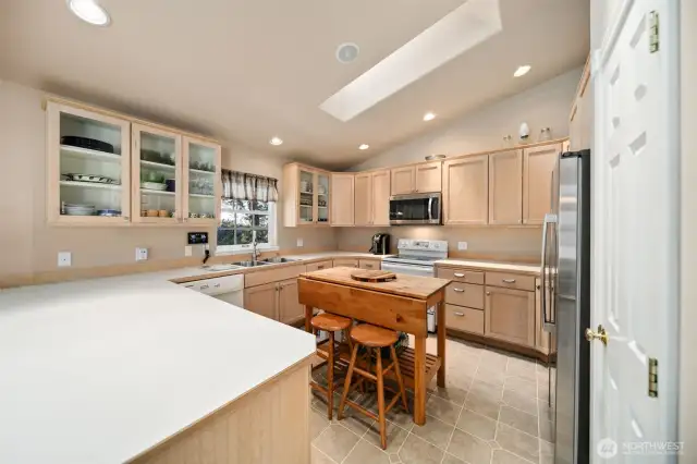 Large kitchen with skylight and pantry to the right.