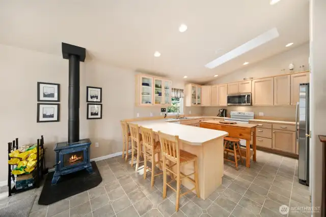 Kitchen and dining room area, with woodstove.