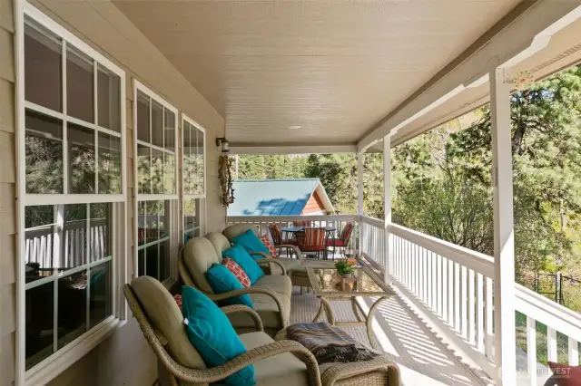 Covered deck with garage in background.
