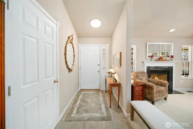 Entrance with coat closet to the left and living room to the right.