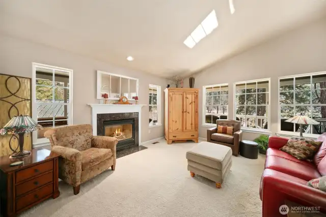 Spacious living room with lots of windows to let in the views and the light.