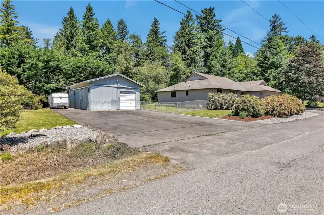 1,180 sqft shop with 2 big doors, 1 side door. 4,000 sqft paved parking. Left side of shop is ready for lean to with ledger board & brackets for support.