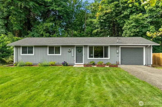 The lush, green front yard features pretty, low maintenance landscaping and the private, peaceful backyard, is cleared and ready for hydroseed and your creativity!