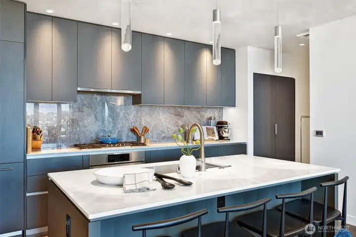Host fun evenings gathered around the kitchen island as the sun sets over the city just behind you.