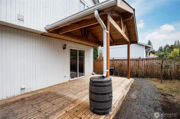 Covered deck with a rain barrel