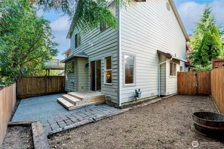 outdoor patio featuring fresh bark, patio, and new outdoor steps backing a beautiful greenbelt that provides privacy and peace and quiet.