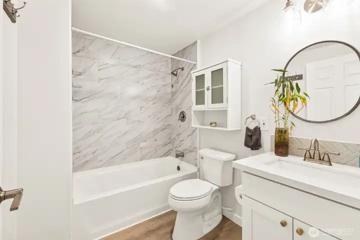 Main floor full bath. New cabinetry and quartz countertops.