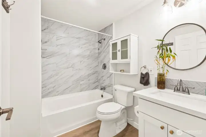 Main floor full bath. New cabinetry and quartz countertops.
