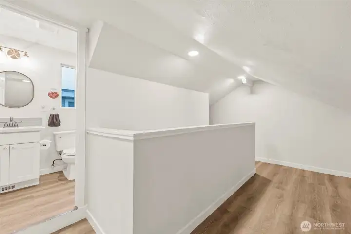 View from bedroom 3 into full bathroom and landing area.