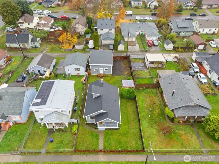 Aerial view of home. Spacious lot. Newer roof, 75 year foundation warranty, new sewer line.