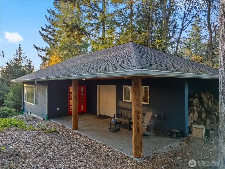 Studio patio. French doors lead to finished storage room w/concrete flooring. Catchment system is just below with the filtration system in the storage room.