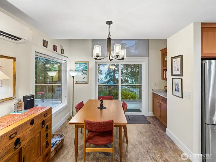 Dining area off of kitchen. Sliders lead to the deck. Water views through the windows.