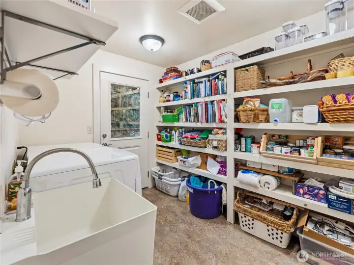 pantry/laundry room. Door leads to deck. Another door to the garage not shown. Standing in door to livingroom/kitchen area
