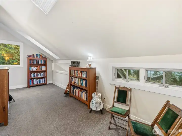 Up the stairs is the library bright with skylights. Room pass through leads to bathroom and two bedrooms