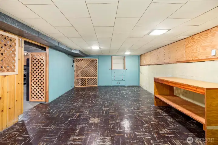 Partially finished basement with wine cellar wine cabinet.