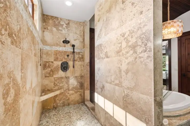 The oversized double walk-in shower offers a spa-like experience with dual access, extensive tilework, and ample room to move—thoughtfully designed to complement the suite’s luxurious feel.