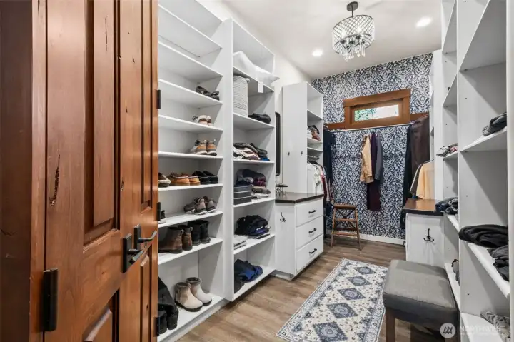 Enjoy a boutique-style walk-in closet with custom storage throughout—designed to keep everything organized, visible, and effortlessly within reach