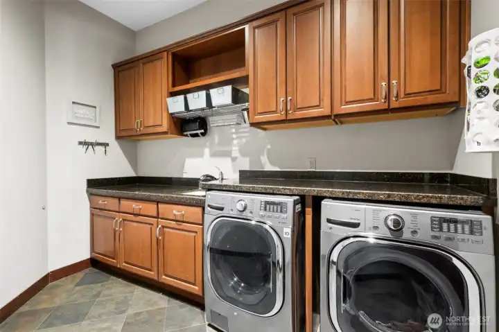 The laundry is beautiful too! - And practical with plenty of wood cabinets and the granite folding counters!