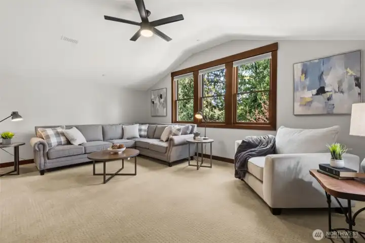 Welcome to the private upper-level bonus room! Designed with flexibility in mind, this upstairs bonus area functions beautifully as fantastic media or game room AND/OR a private living suite—featuring a spacious private bedroom, full bath, and plumbing for a future kitchenette.