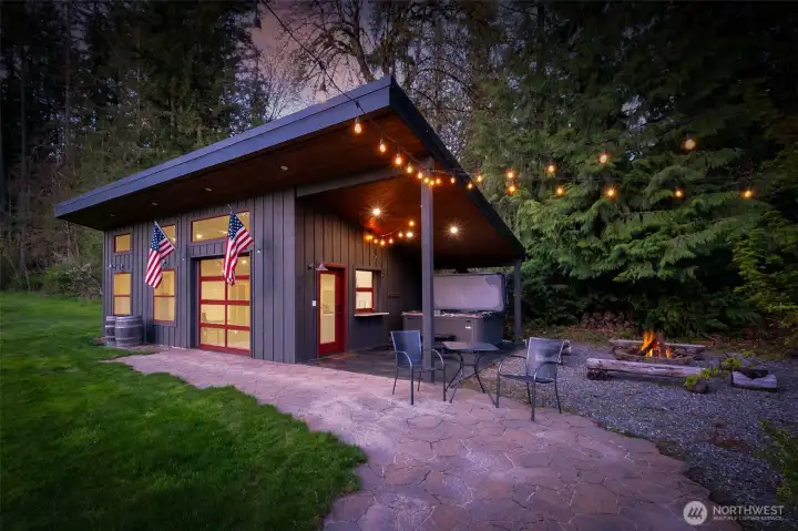 The architecturally rich, versatile detached cabana/studio offers exceptional flexibility—perfectly positioned on the expansive, level lawn and ideal for gatherings, celebrations, or everyday enjoyment. Currently used as an exercise space, it is fully equipped with a bath and kitchenette, making it a turnkey option for a guest suite, studio, or potential ADU