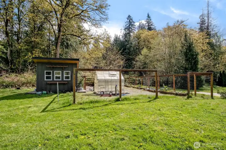 A spacious, fully fenced garden area offers a true outdoor retreat, complete with a greenhouse and charming garden shed—perfect for year-round growing, hobbies, or simply enjoying the natural surroundings. (With plenty of space to enlarge the garden!)