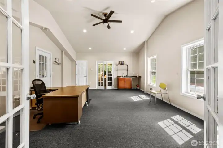 Surprisingly large, this upper level office in the shop has room for everything. There is a private work station at either end of the space, plus this large middle area for special projects, AND a convenient bathroom.