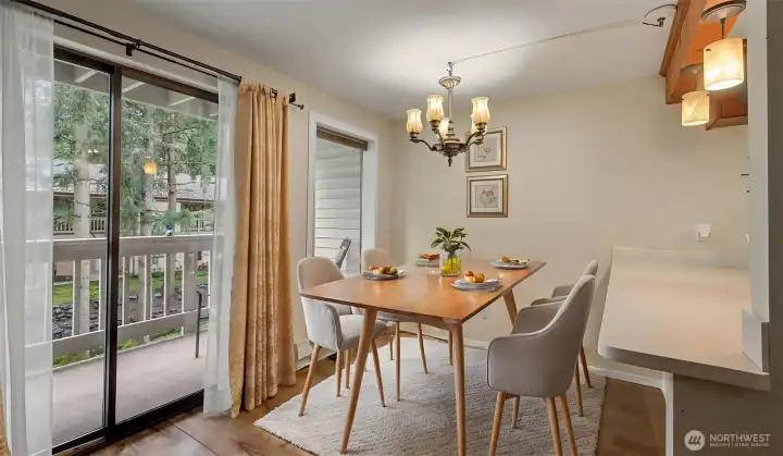This virtually staged dining area overlooking the balcony.