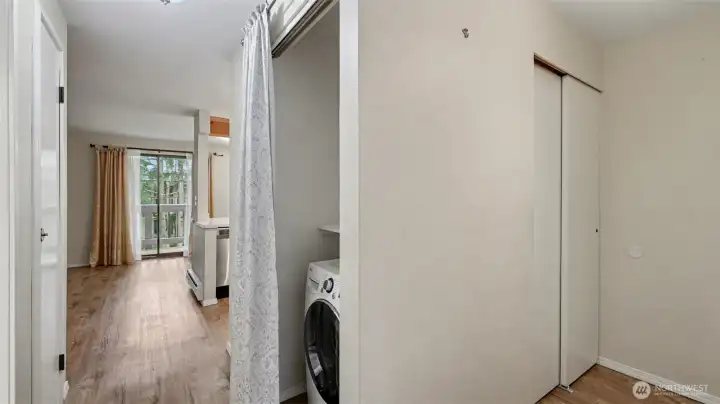 An open laundry closet in the center hallway.